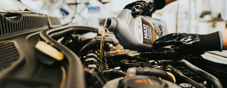 oil being poured into vehicle engine